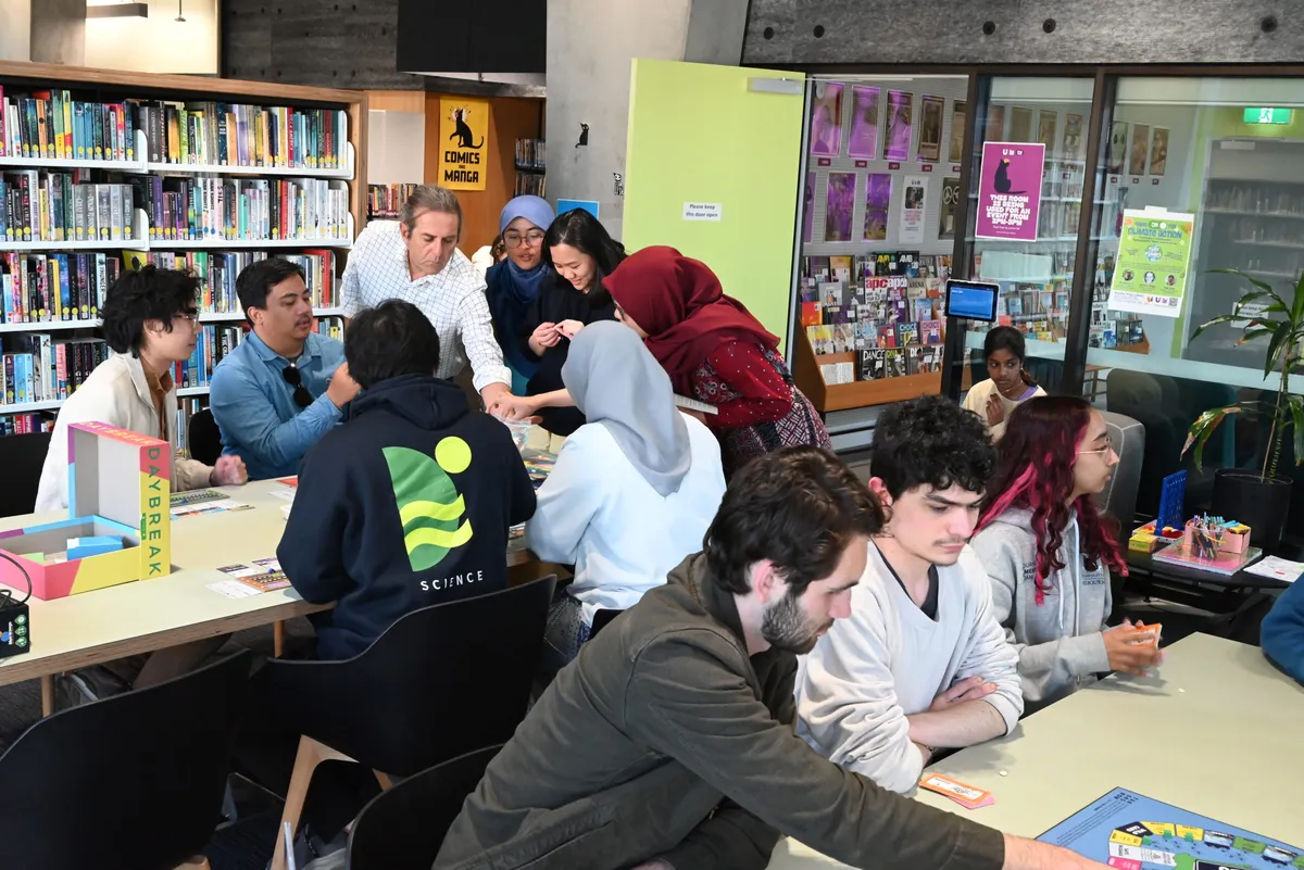 Students playing board games in a library,