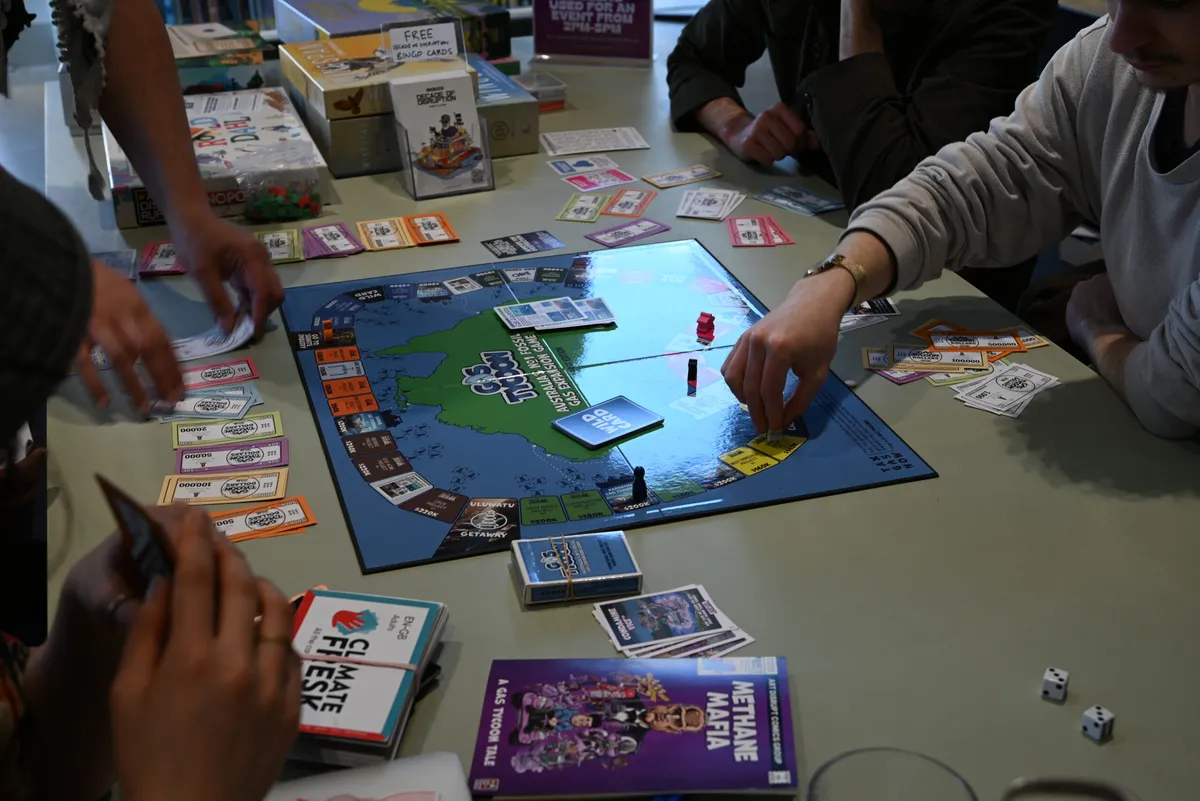 Students playing a board game called Gas Tycoon at Melbourne University.
