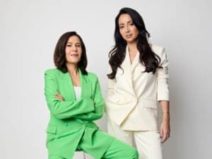 Photo of Ette Media's Jan Fran in a green suit and Antoinette Lattouf in a white suit