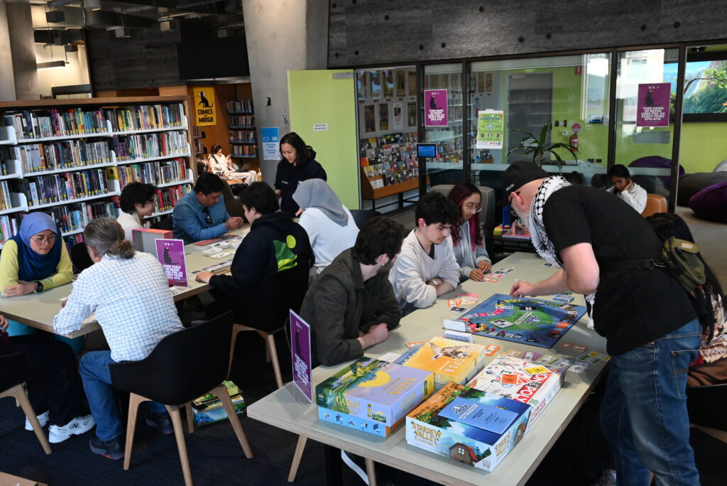 Students playing board games at the launch of Melbourne University's board game library.